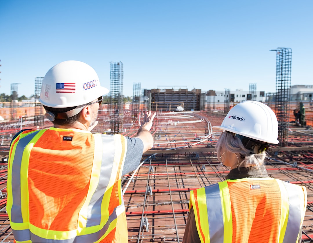 man-in-white-hard-hat-standing-on-brown-wooden-dock-during-daytime-80zz1s24nag